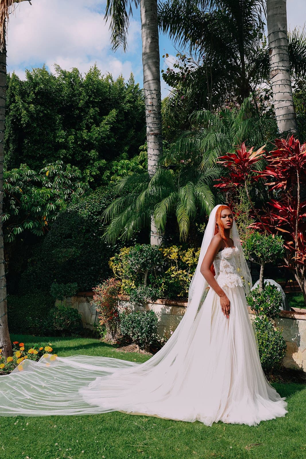 Bride in the Seraphine two-piece Italian tulle gown with cathedral veil and sweeping train, in a garden