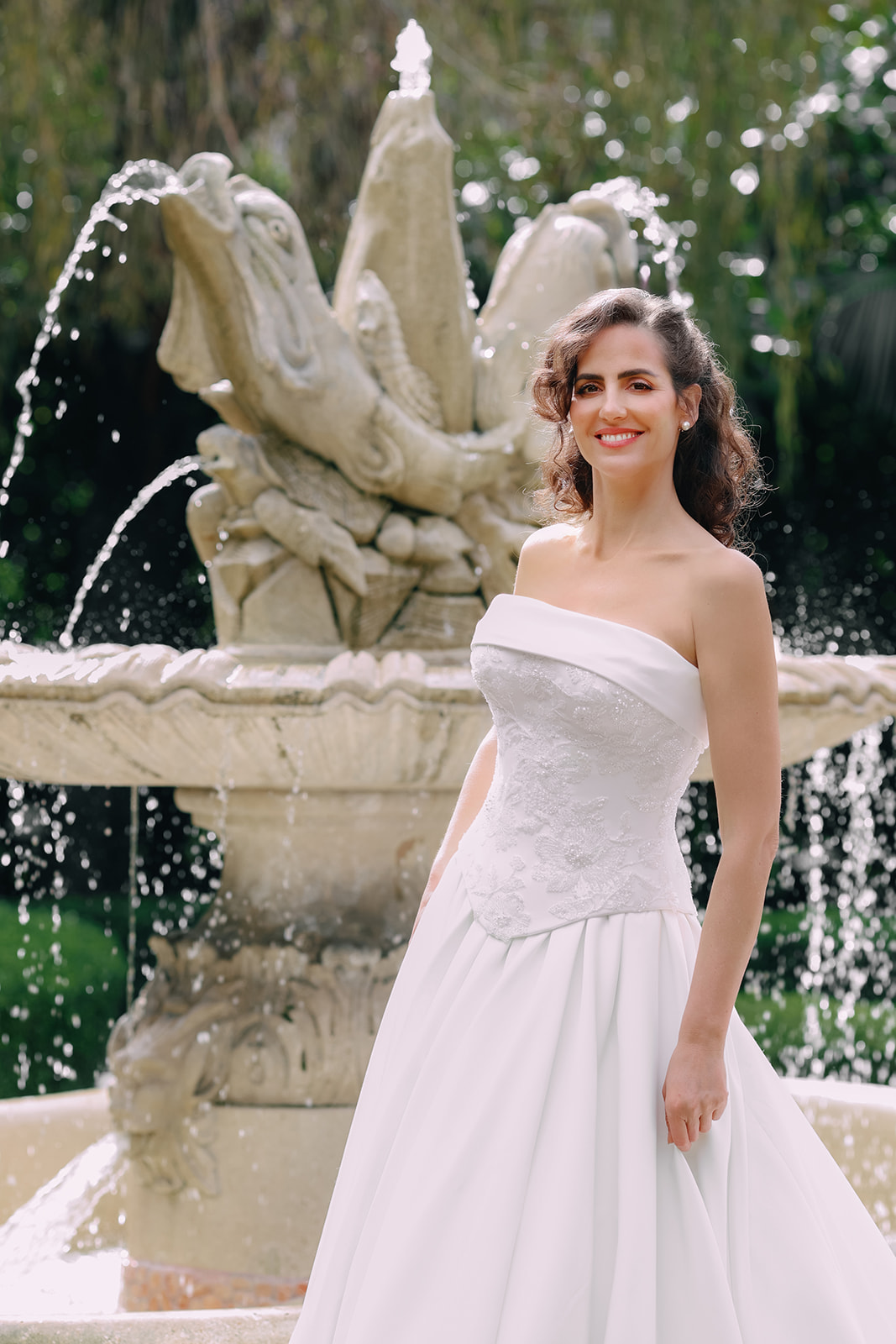 Close-up of a luxurious strapless wedding gown featuring a beaded floral corset bodice and structured satin skirt.